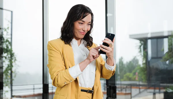 Imagem de uma mulher olhando para o celular